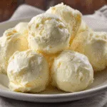 Plain carnivore cream cheese bites scooped onto a plate.