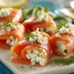Smoked salmon slices rolled with herb cream cheese and topped with dill
